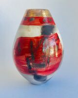Red smoke-fired pot with gold lustre.