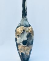 Smoke fired pot with long neck.