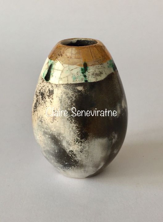 Upright smoke fired pot with gold.