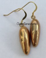 Gold teardrop earrings.