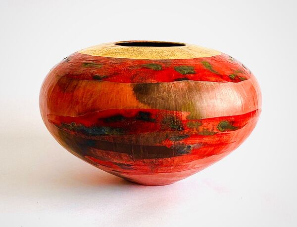Red smoke-fired pot with gold lustre.