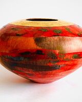 Red smoke-fired pot with gold lustre.