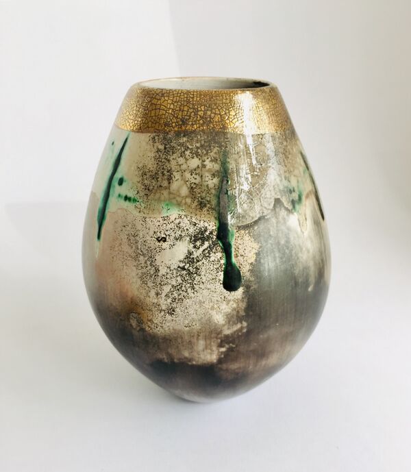 Sawdust fired ceramic pot partial glaze and gold lustre.