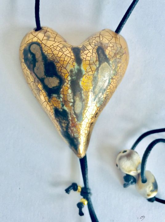 Large gold heart pendant with crackled textures.