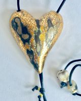 Large gold heart pendant with crackled textures.