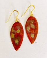 Red leaf shaped ceramic drop earrings with matt gold patterns.