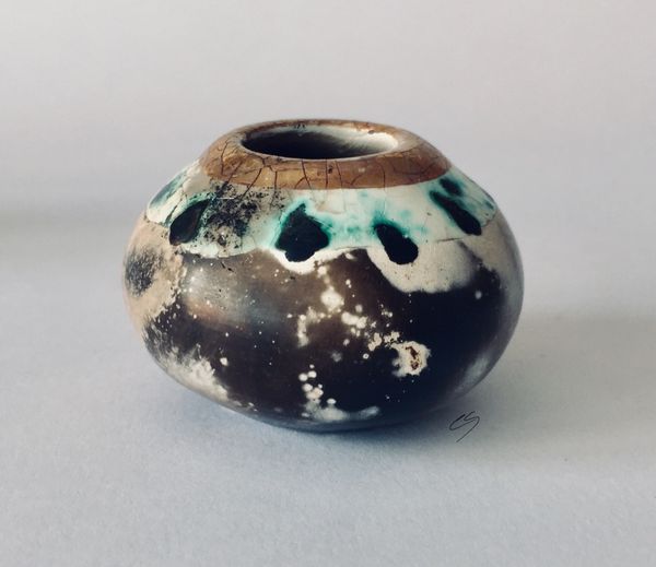 Small smoke fired pot with gold.