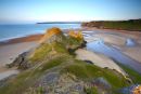 A summer Dawn breaks over Three Cliffs Bay