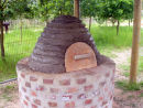Beehive design of an earth oven, with wooden door