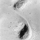 abstract black and white photograph of wave washed footprints on a sandy beach in Lagos, Portugal