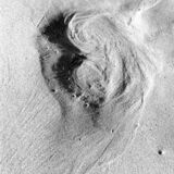 abstract black and white photograph of wave washed footprints on a sandy beach in Lagos, Portugal