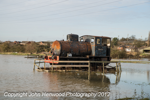 Sunday 23rd December 2012,Blaby, Leicestershire,UK. Flood waters surround Bullseye a steam engine built in 1929 and placed in a field by farmer Peter Thomas calling for the return of the defunct Blaby Station.