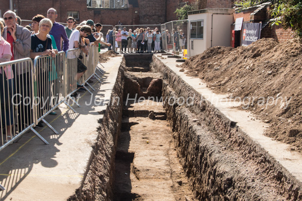 Members of the public view the trenches dug during the dig