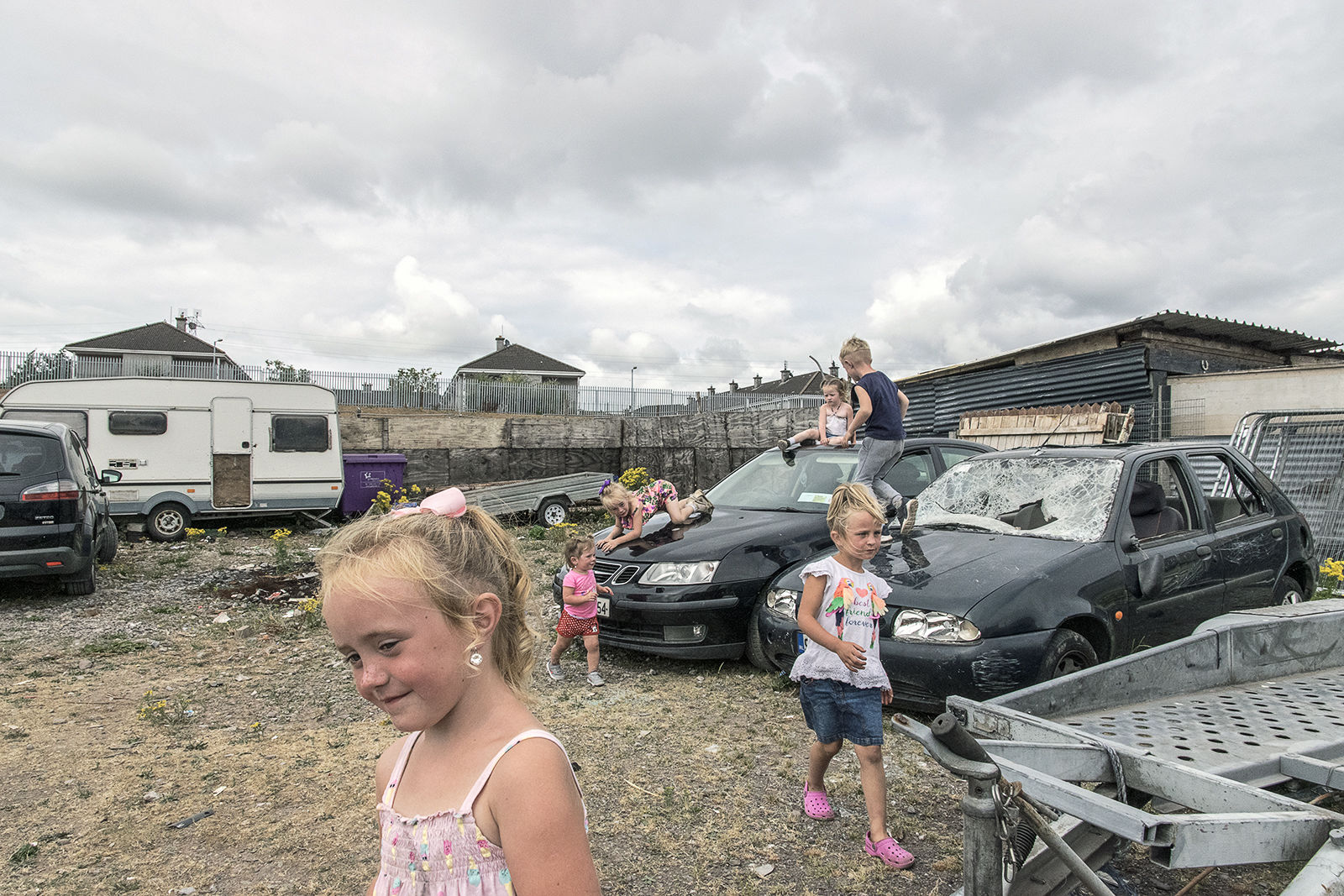 Children playing in scrap yard, Cork, Ireland 2018