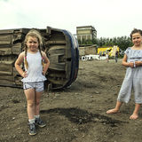 Girls in their father's scrapyard, roadside campsite, Limerick, Ireland 2018