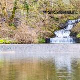 Mountain cascades into Dare Valley Park lake