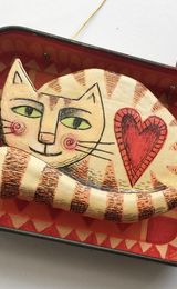 Ginger Cat on an Orange and Red Rug.