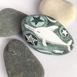 Dreamy Dolphin swimming while asleep. Handpainted Stone.