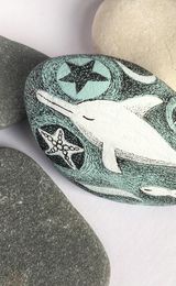 Dreamy white dolphin hand-painted stone.