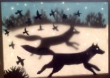 Running Wolves backlit in window.