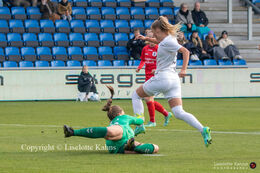 Olivia Holdt (#13 Fortuna Hjorring) trying to pass Sofie Gron (#28 AGF) in the "Kvindeliga" match Fortuna Hjorring vs. AGF at "Bredbaand Nord Arena" in Hjorring, Denmark