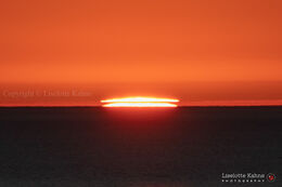 Sun sliced by temperature inversions