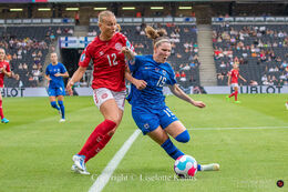 Stine Larsen (#12 Denmark) battles for the ball in the Women's Euro 2022 match Denmark vs Finland at Stadium MK, Milton Keynes, England