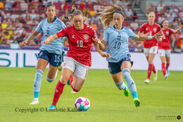 Janni Thomsen (#19 Denmark) battles for the ball in the Women's Euro 2022 match Denmark vs Spain at Brentford Stadium, London, England