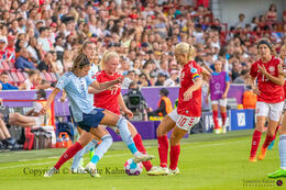 Rikke madsen (#17 Denmark) and Pernille Harder (#10 Denmark) battle for the ball in the Women's Euro 2022 match Denmark vs Spain at Brentford Stadium, London, England