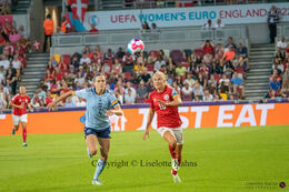 Pernille Harder (#10 Denmark) battles for the ball in the Women's Euro 2022 match Denmark vs Spain at Brentford Stadium, London, England