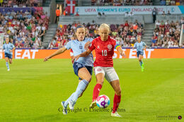 Pernille Harder (#10 Denmark) battles for the ball in the Women's Euro 2022 match Denmark vs Spain at Brentford Stadium, London, England