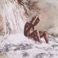 Boy bathing in waterfall