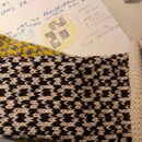 Close up of design notes and knitted swatches