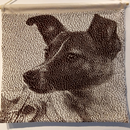 Knitted picture of Laika the space dog in dark brown and cream