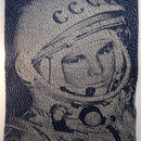 knitted portrait of Yuri Gagarin in dark blue and grey