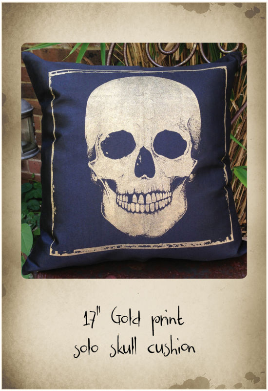 17" black cushion with gold skull print