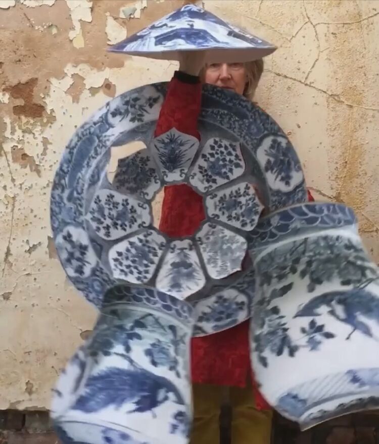Stephanie Douet holding blue and white sculptures