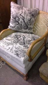 £1200.English 'Bergere' chair, 1900, beech frame stripped, new cane work, traditionally built and covered with an artist linen and French printed linen. £1200.00 Sofa also available.