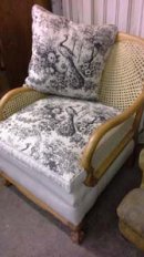 £1200.English 'Bergere' chair, 1900, beech frame stripped, new cane work, traditionally built and covered with an artist linen and French printed linen. £1200.00 Sofa also available.
