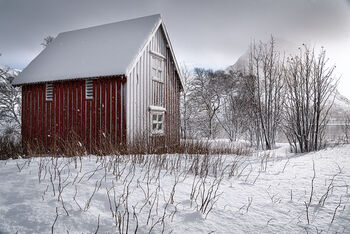 Rorbu in snowfall, Senja, arctic Norway