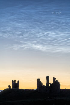 Noctilucent clouds over Dunstanburgh Castle, England