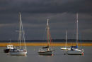Boats against stormy sky