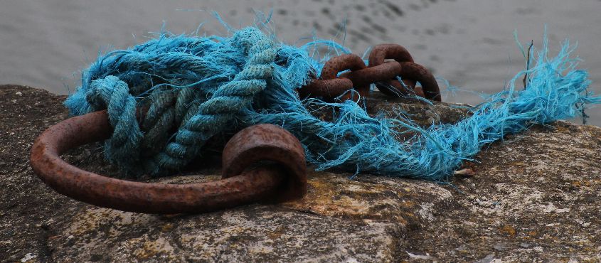Rusty ring with blue rope