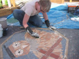 Nicola installing the owl mosaic at Swaffham Junior School, Norfolk