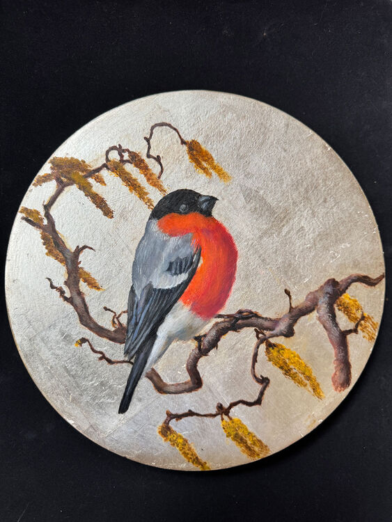 Round painting of a bullfinch on a branch
