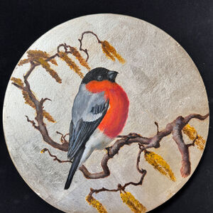 Round painting of a bullfinch on a branch