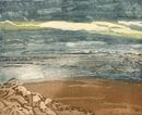 Breaking Through A stomy sky with bright light on the clouds and a beach with dark waves