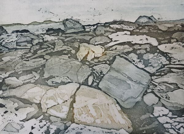 rocks of varying colours on a beach.  Many of the rocks are broken, but you can see the original shapes