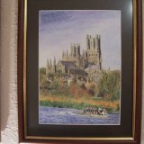 A Cambridge eight on the Great Ouse at Ely, whose cathedral founded in 1109 has the third longest nave in Britain and whose building was funded in the 12th century at 8,000 eels a year via local catchers and Peterborough Abbey which owned the Barnack stone quarry. SOLD 2019