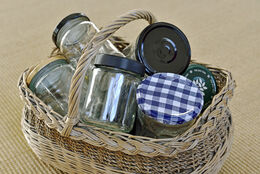 Glass jars for reuse in old wicker basket